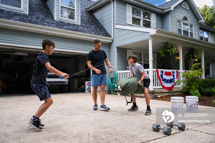 Air Force service member trains with his sons in a morning workout in preperation for a PT fitness test.