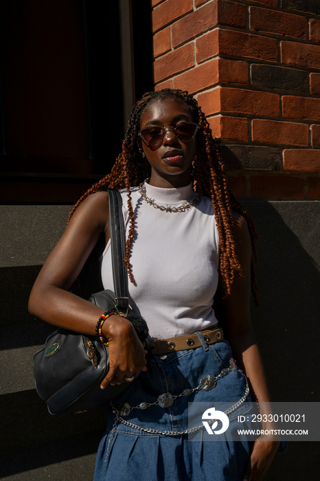 Portrait of woman wearing white top and sunglasses