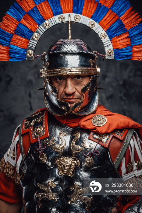 Studio shot of fearful roman soldier with colorful plumed helmet