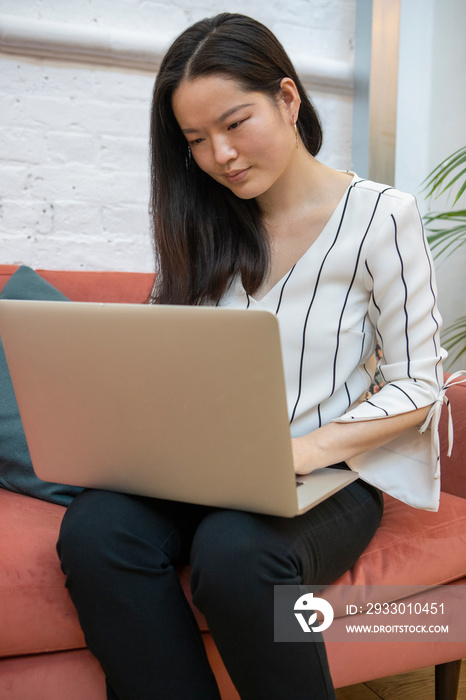 Woman using laptop at home