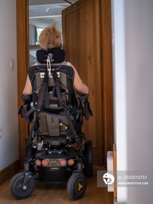 Woman in electric wheelchair going through automatic doors