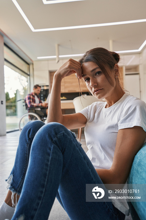 Beautiful elegant female holding hand near the head in home apartments