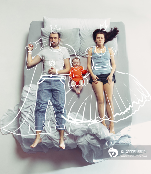 Top view of happy family with one newborn child in bedroom and their dreams .