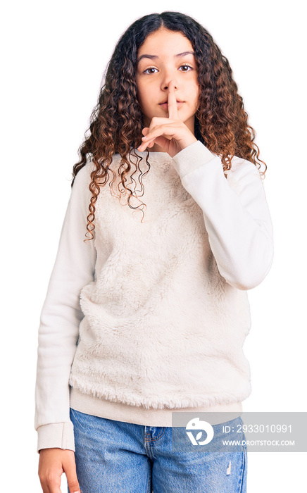 Beautiful kid girl with curly hair wearing casual clothes asking to be quiet with finger on lips. silence and secret concept.