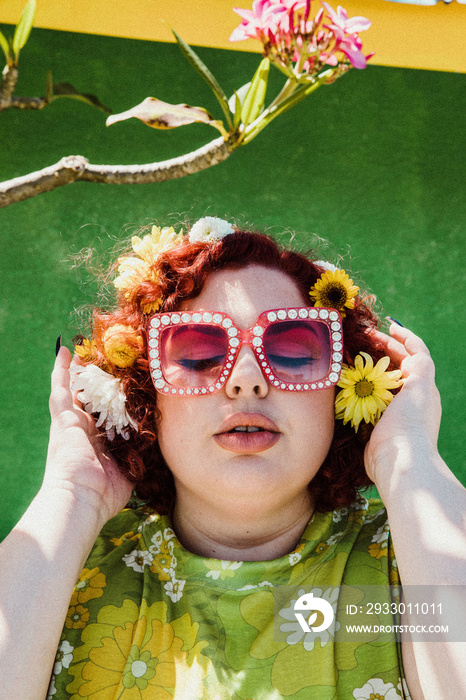 closeup of woman with red hair and shiny sunglasses eyes closed