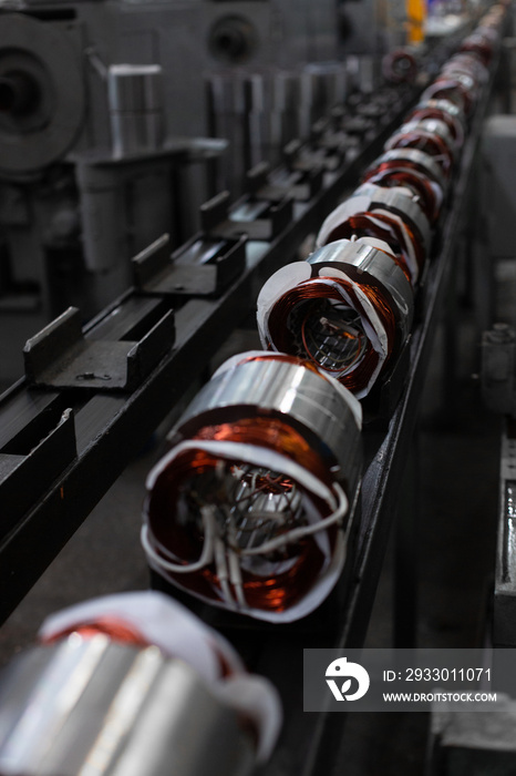 Long conveyor line for production of electric motors. industrial company manufacture - stators on assembly line of Semi-automated manual production. 20th century technology, obsolete factory processes