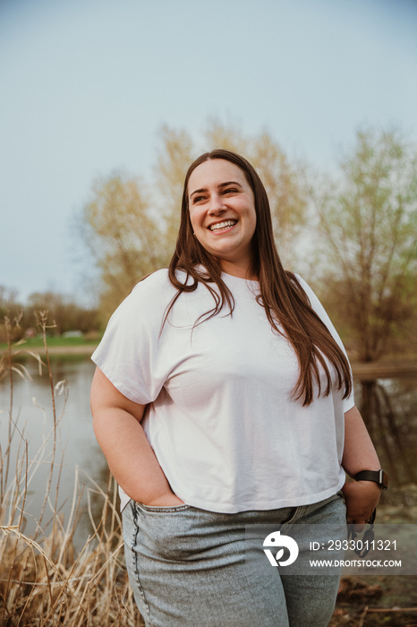 portrait of a plus size woman smiling outside