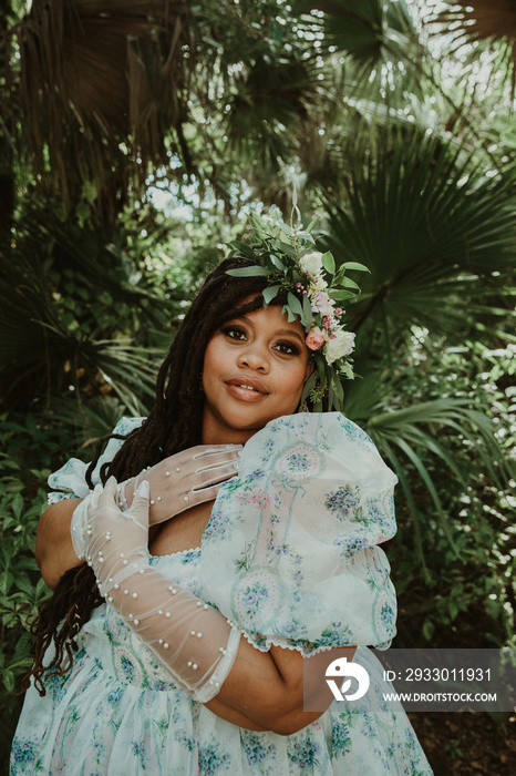 portrait of a plus size woman with hands on chest