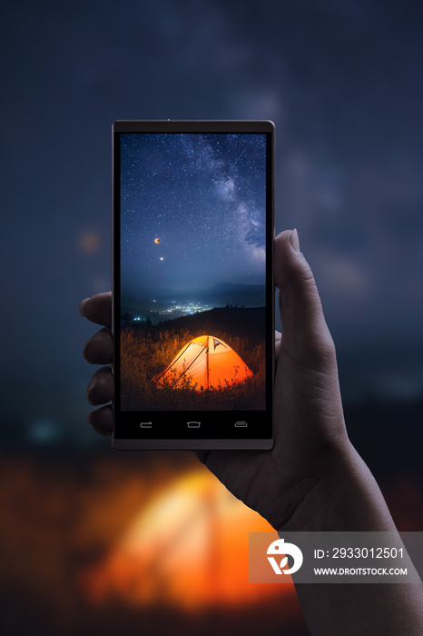 Tent under night starry sky with moon eclipse and milky way