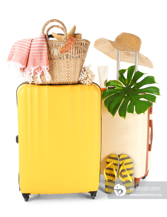 Packed suitcases with beach accessories on white background. Travel concept