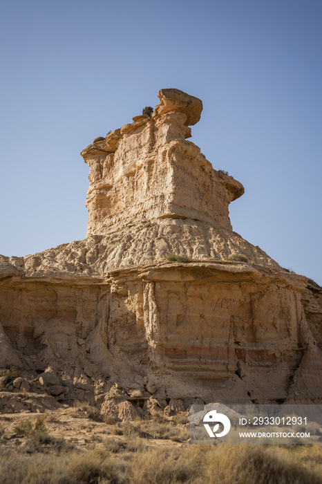 The landscape of a spectacular rock formation in the Monegros Desert in Huesca, Spain, on a sunny summer day with a clear blue sky