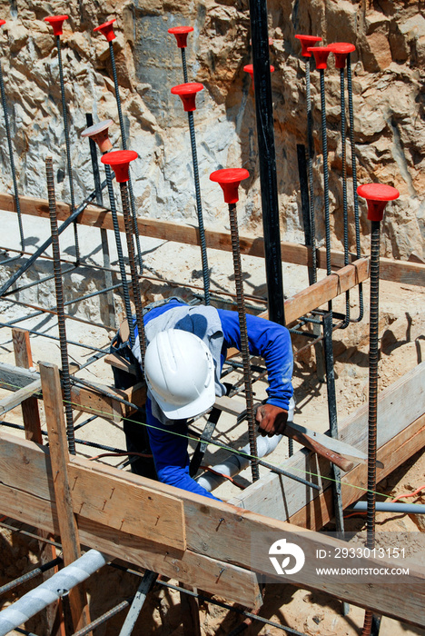 Mason setting wood forms for concrete foundation