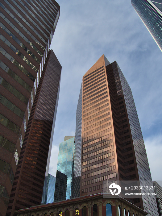 Stunning low angle view of modern high-rise office buildings in the downtown of Calgary, Alberta, Canada in the afternoon light in autumn season.