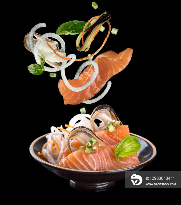 Levitation sashimi with salmon and mussel in a black plate. On a black background with reflection.