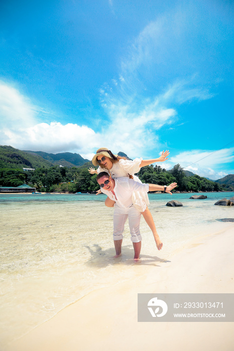 Happy couple enjoys life on a tropical paradise island, Seychelles