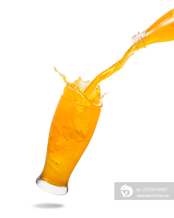 Pouring orange juice from bottle into glass with splashing isolated on white background.