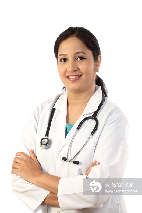 Happy young female doctor against white background