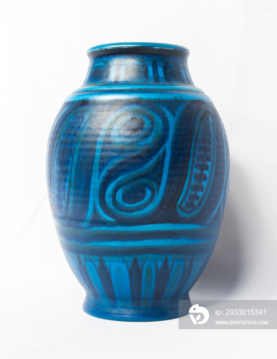 A vintage antique ceramic fragile pottery royal blue vase isolated on a white background. old pottery pots and objects from the past, found in junk shops and thrift stores.