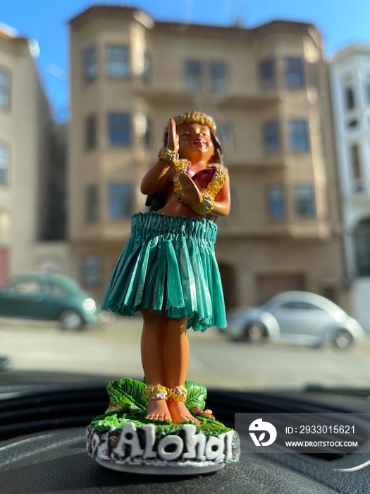 Hula girl bobble head with the view of San Francisco neighborhood in the background.