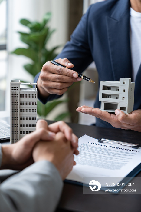 Entrepreneur, business owner, accountant, real estate agent A young Asian insurance agent explains the details of the condo purchase contract to calculate the financial risk for the client.