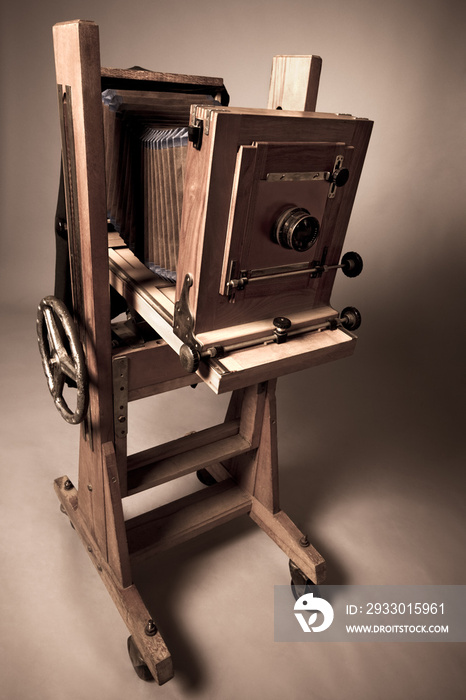 Close-up wooden vintage daguerreotype camera stands in studio. Concept of retro photography and vintage style. Concept of the first photos. Copyspace