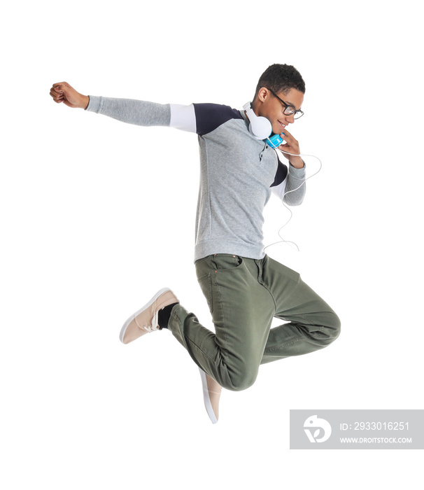 Portrait of jumping African-American teenage boy on white background