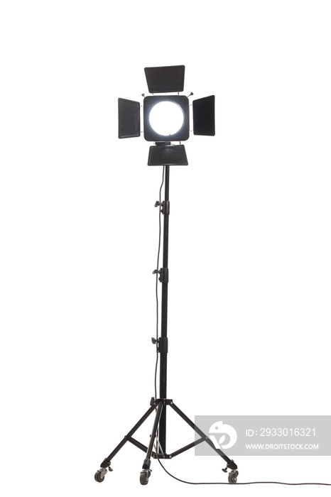 Flash light with barn doors on stand with wheels. Studio lighting equipment isolated on white background