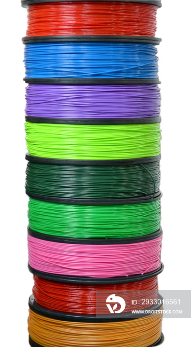 Filament wire for 3D printer close-up. Reels of filament wire for 3D printer different colors. Material produced from FDM printing technology. Many reels vertical view. Isolated on white background