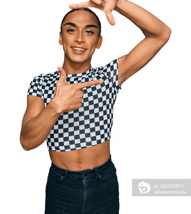 Hispanic transgender man wearing make up and long hair wearing modern clothes smiling making frame with hands and fingers with happy face. creativity and photography concept.