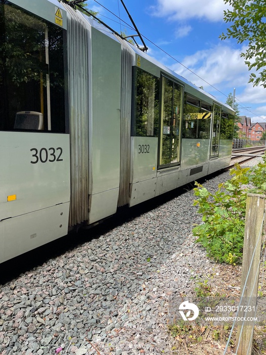 Close up of a moving tram going past through Didsbury in Manchester England. Metrolink tram.