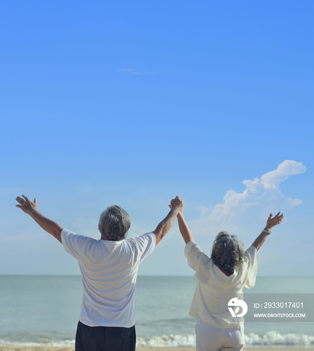 Asian senior love couple travel on the beach. Retirement age family relaxing and recreation on summer holiday.