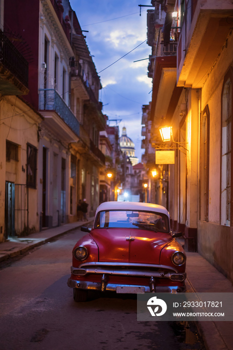 Amazing old american car on streets of Havana with Capitolio Building in background during night. Havana, Cuba.