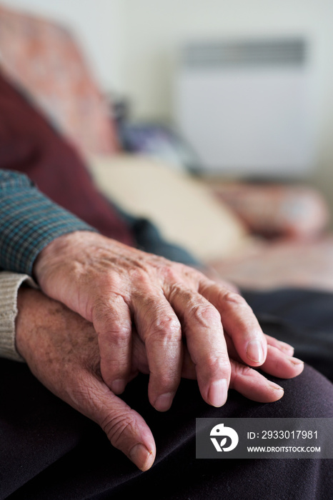 old man and old woman holding hands