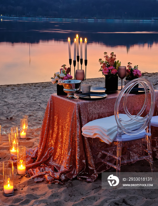 A date on the river bank, a decorated table is waiting for a couple in love. Evening Kyiv, Ukraine.