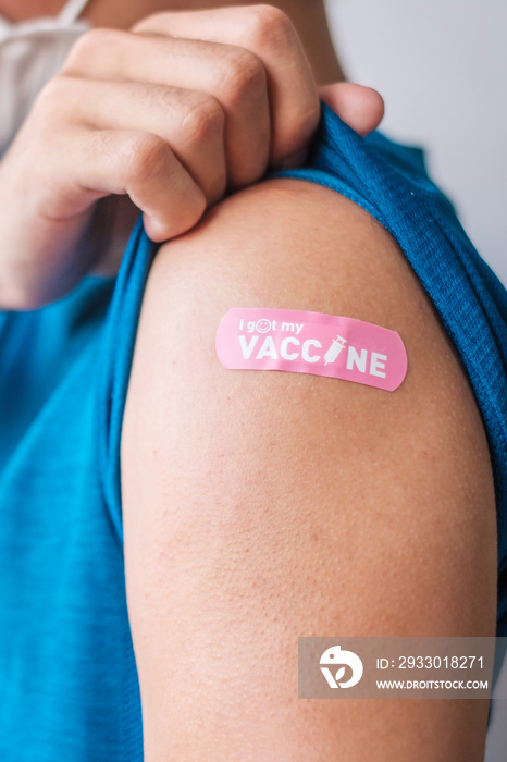 man showing bandage after receiving covid 19 vaccine. Vaccination, herd immunity, side effect, booster dose, vaccine passport and Coronavirus pandemic