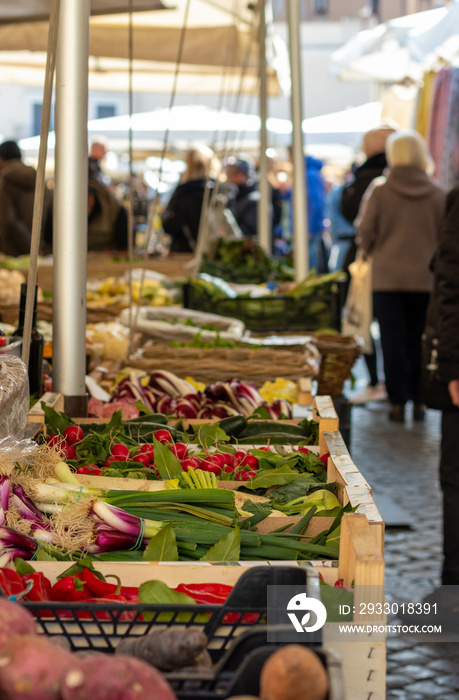 People buying fruits and vegetables at the market of Campo Di’ Fiori in Rome