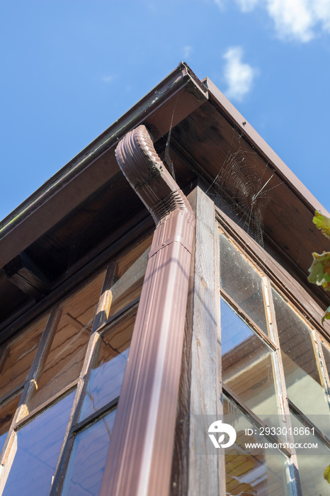 Gutter draining rainwater. The building is equipped with drainage of rainwater from the roof.