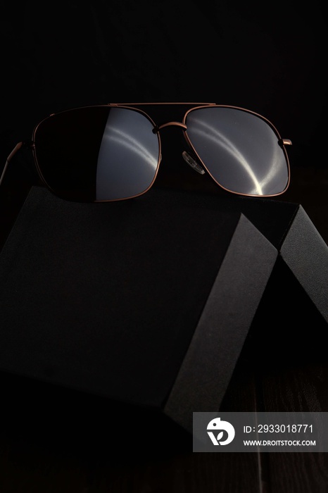 Brown Sunglass on the black case with dark background