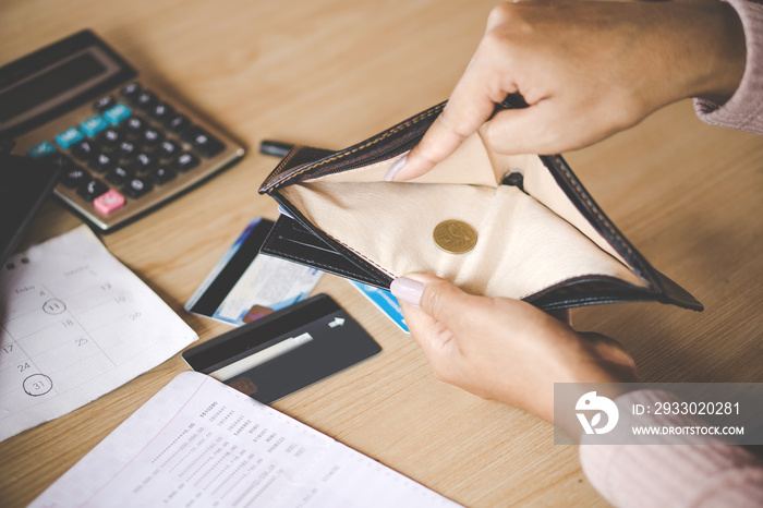 poor Asian woman hand open empty purse with only one coin left bankrupt broke after credit card payday