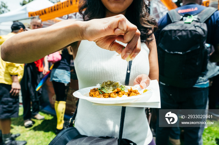 woman squeezing lime on taco