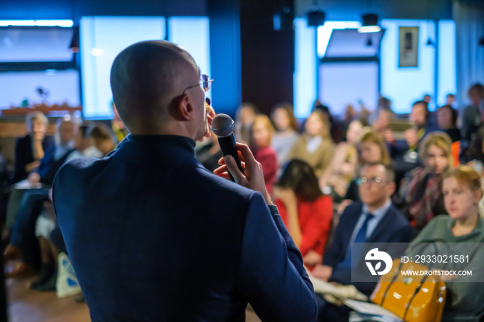 Male presenter speaks to audiences