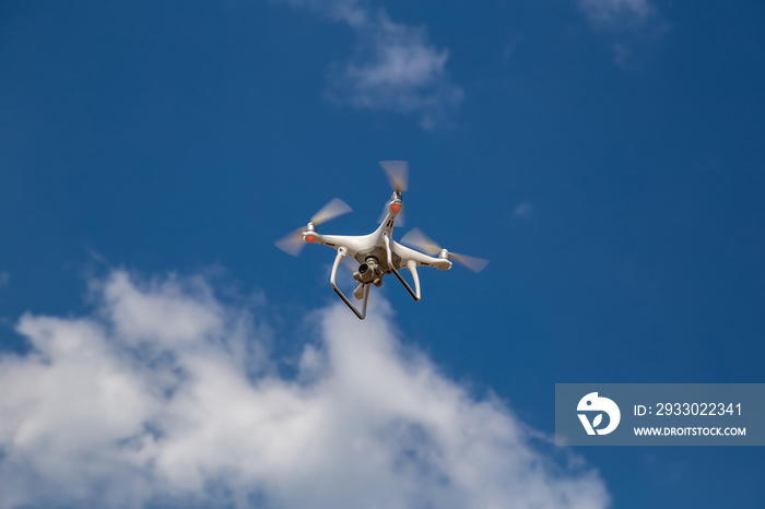 Quadcopter in flight against a blue sky. Drone.