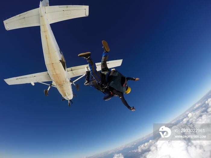 Sky dive tandem above the clouds