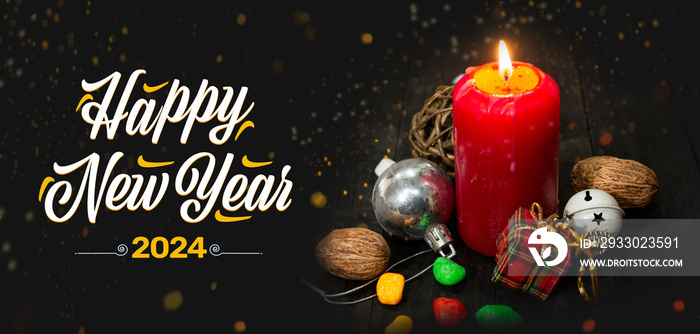 Happy New Year 2024 theme with Red candle and christmas theme on dark table