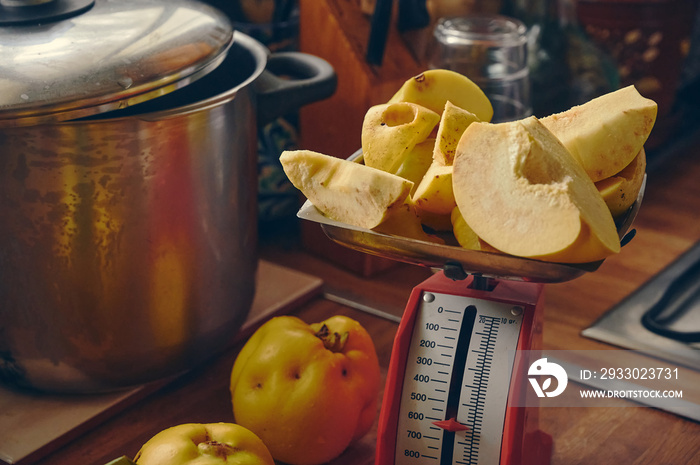 Elaboration of the quince jam recipe, quince fruits on a scale before being cooked in the kitchen.