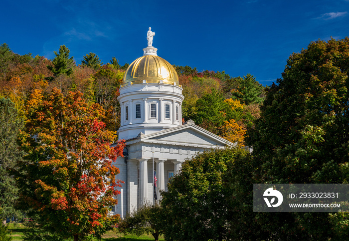 Gold leaf dome of the Vermont State House capitol building in Montpelier, Vermont. Brilliant fall colors surround the building