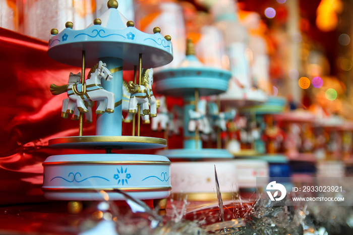 Handmade wooden merry go round miniature sold as a Christmas ornament on sale at a booth of the Christmas market of the Champs Elysées in Paris, France