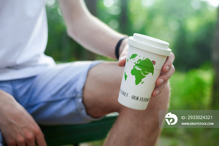 Man holding a reusable cup of coffee