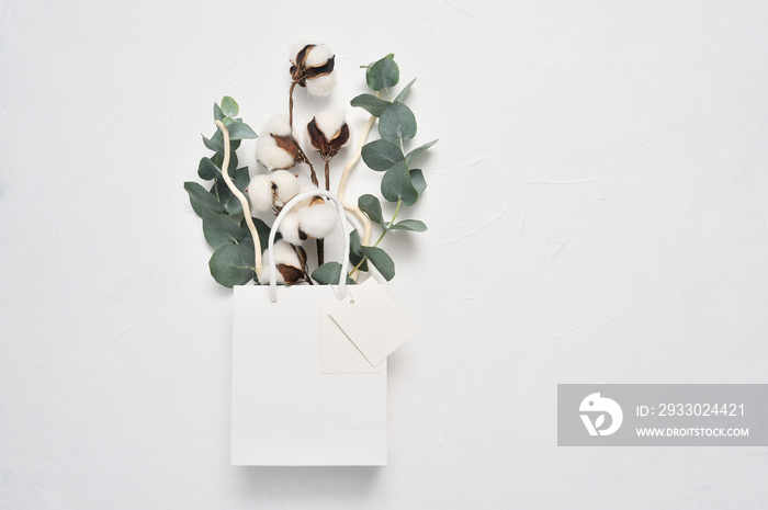 Mock up autumn of dried bouquet of cotton flowers and leaves of eucaliptus in white package with place for your text. Greeting card design for poster, banner or web