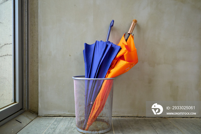 An umbrella standing on the wall